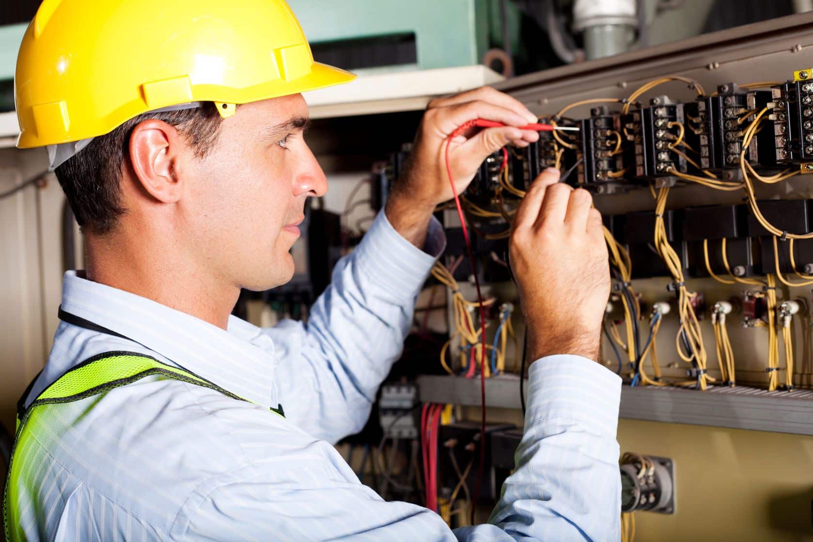12431512 - male electrician testing industrial machine